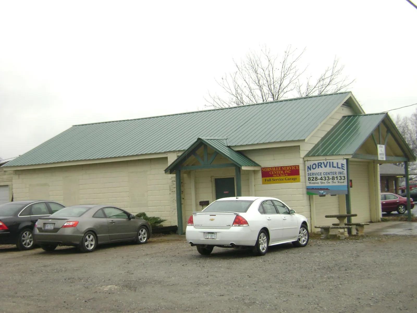 Green metal roof on a service garage with a covered entry in Poland